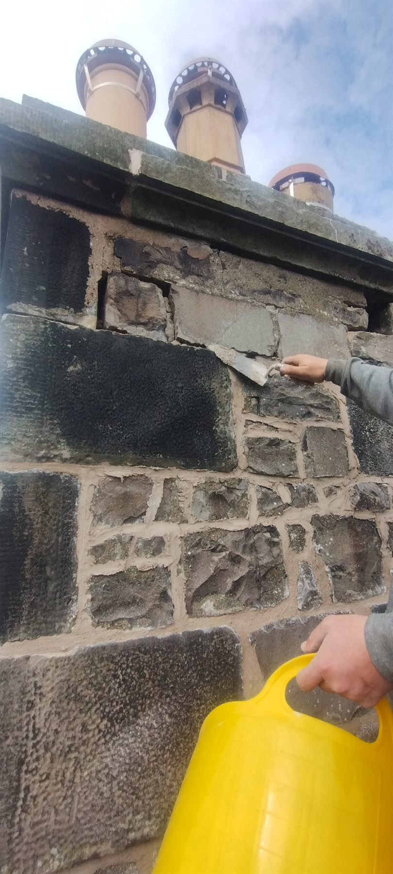 Chimney head repointed — Perished mortar raked out and the stack repointed by hand, with the pots re-bedded and left sitting true.