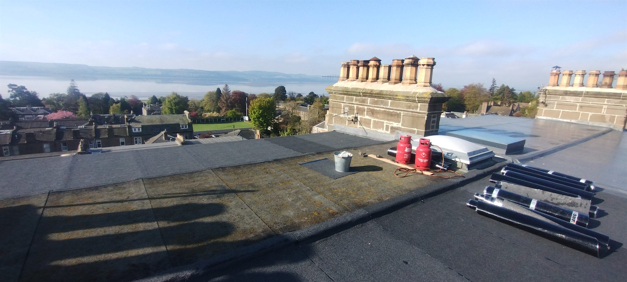 Flat roof stripped back — Old covering lifted and the deck checked over properly before any new torch-on membrane went down.