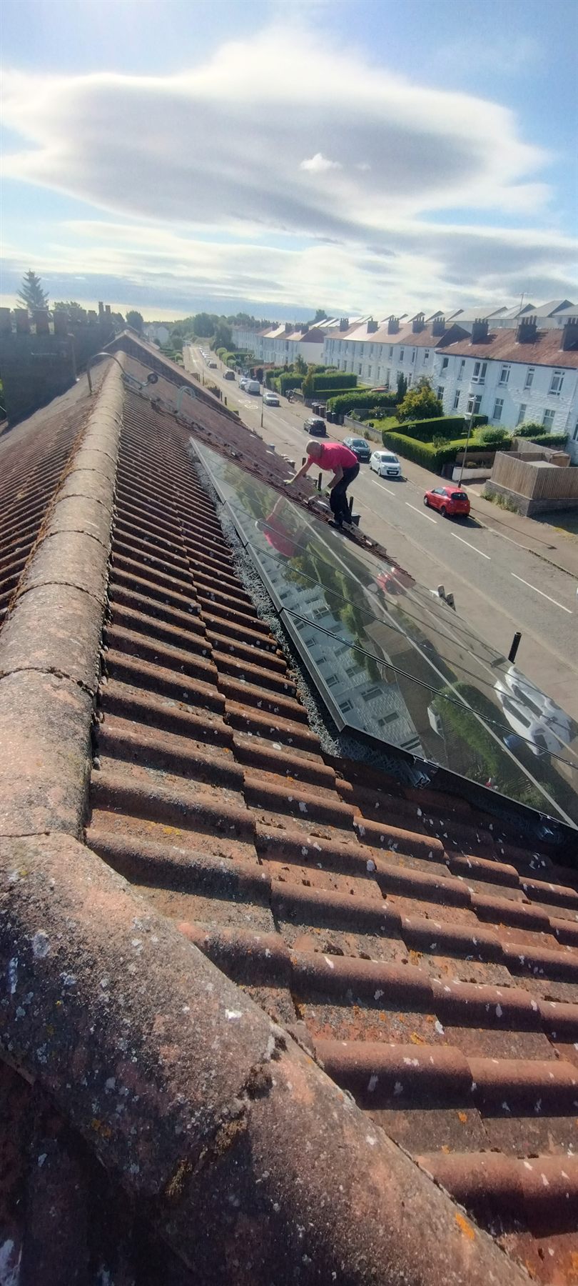 Rooflight made watertight — Flashings around the rooflight lifted, re-dressed and sealed back into the pantiles to stop the drip.